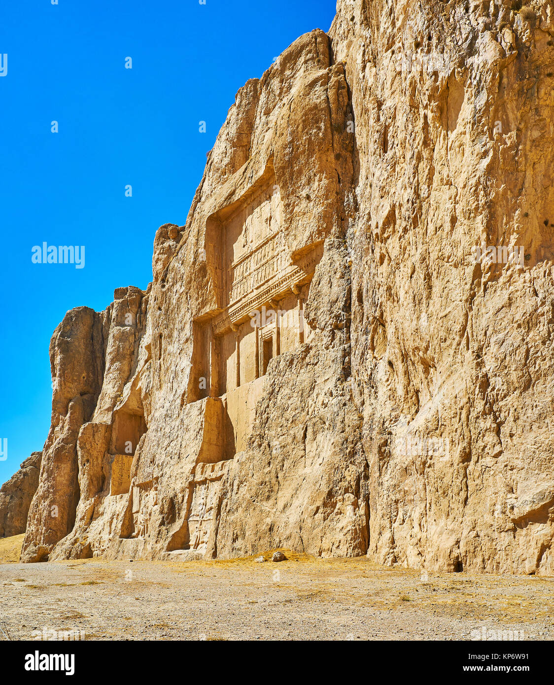 The walk along the huge cliff, famous for the ancient mausoleums, cut in it, Naqsh-e Rustam Necropolis, Iran. Stock Photo