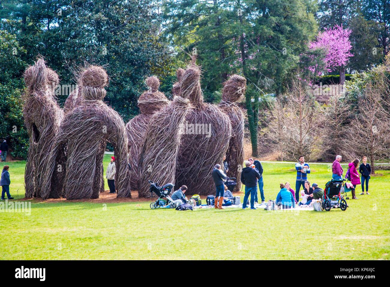 Bunch of wood statues in the middle of gardens as a piece of art made