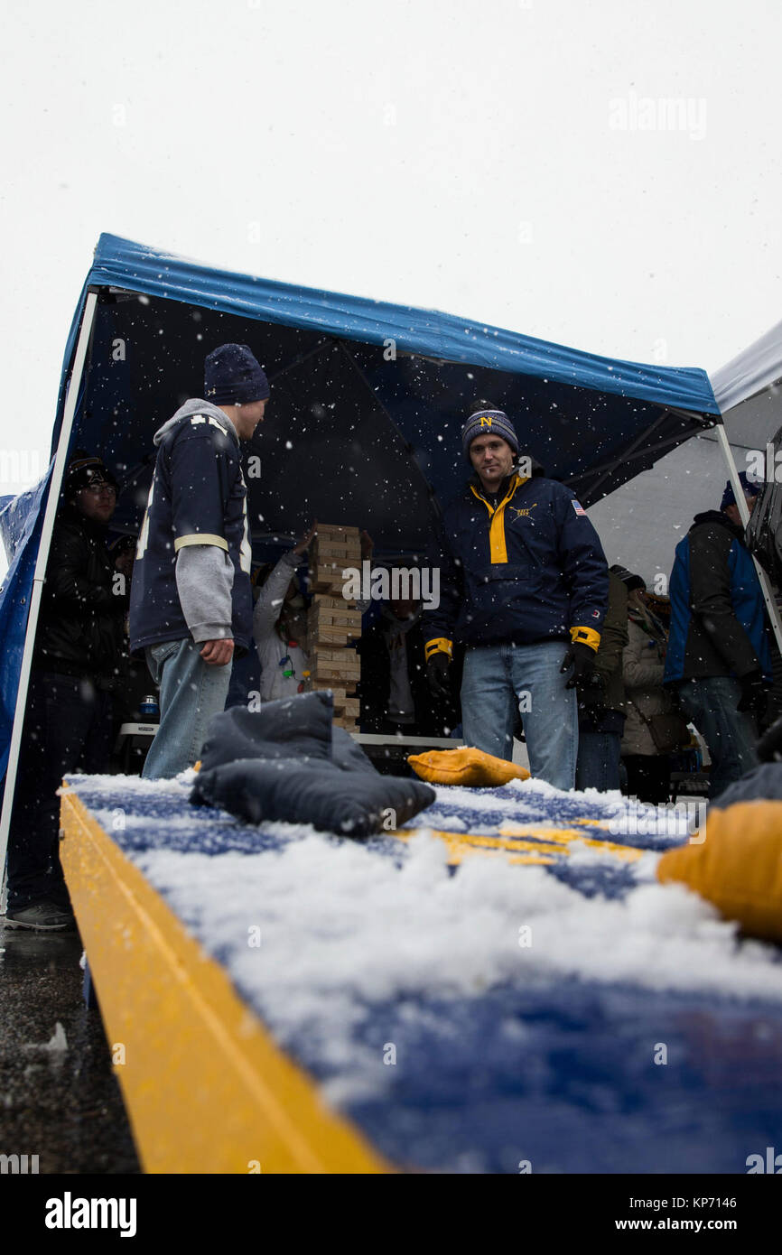 Fans Play Corn Hole While Tailgating In The Parking Lot At