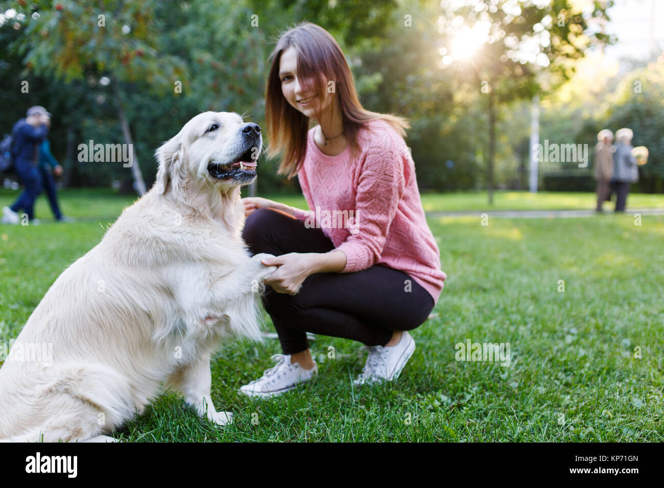 Image of woman with dog on lawn in summer park Stock Photo - Alamy