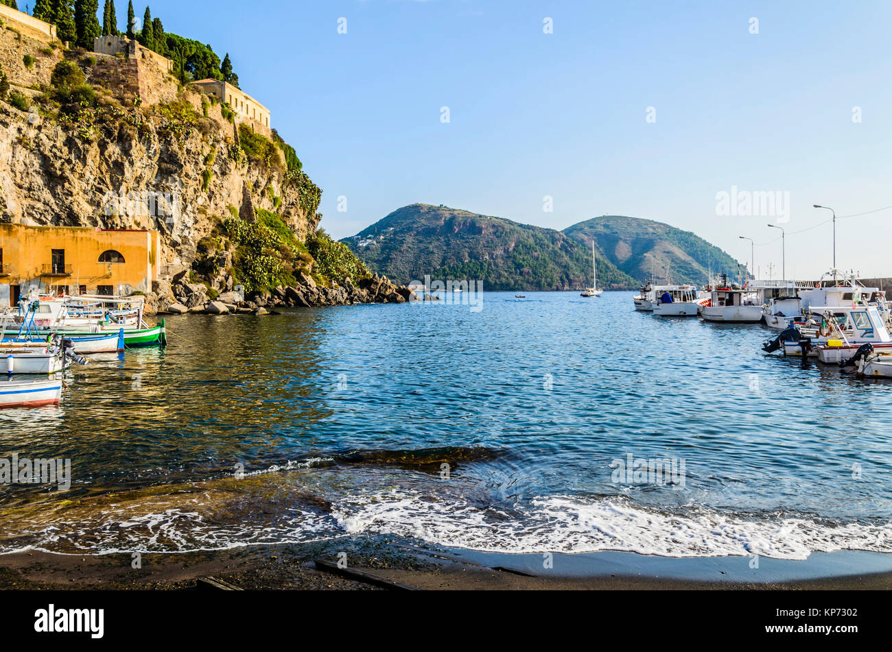 Coast and mooring of fishing boats and stroll on the Tyrrhenian Sea on the eolian  island of  lipari Stock Photo