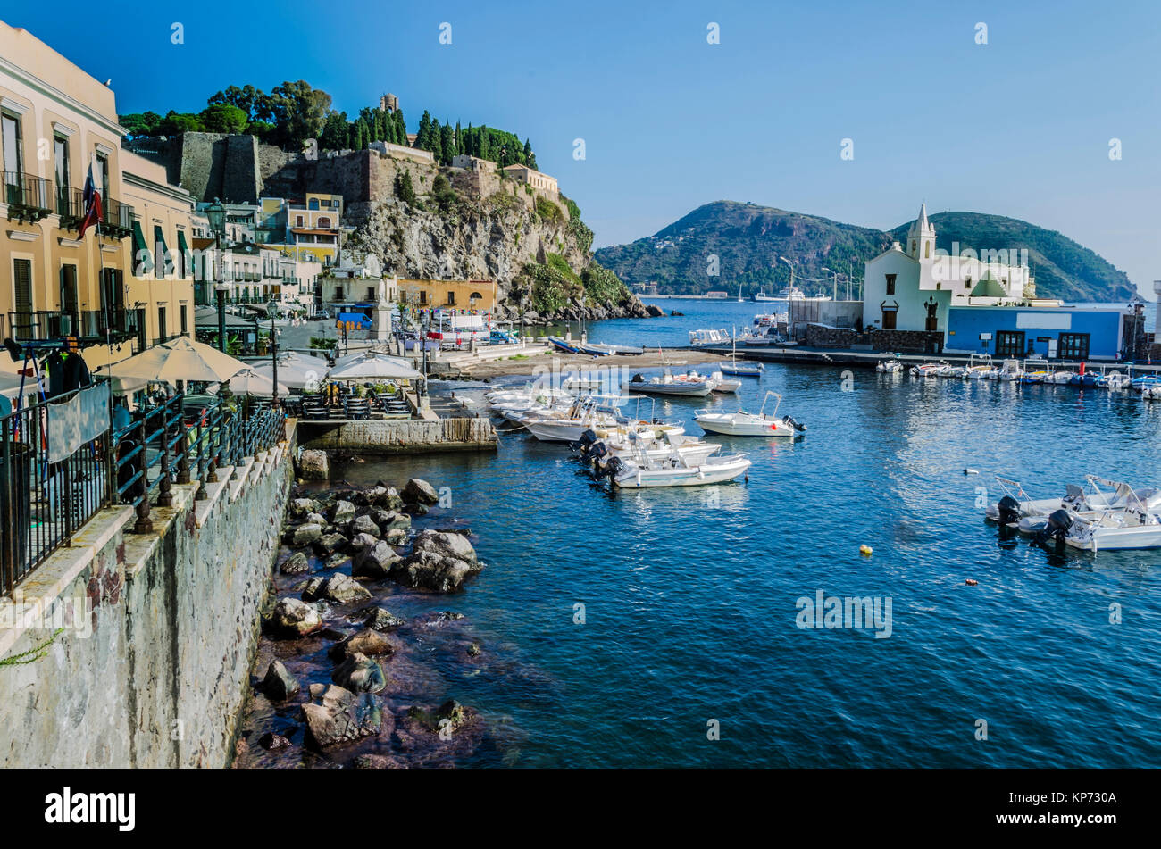 Marina buildings moor of boats and ancient fortress on island of lipari italy Stock Photo