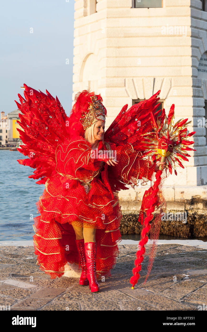 Venice Carnival 2017, Veneto, Italy woman in red Satan costume with wings  ans staff posing at sunset at the lighthouse on San Giorgio maggiore Stock  Photo - Alamy