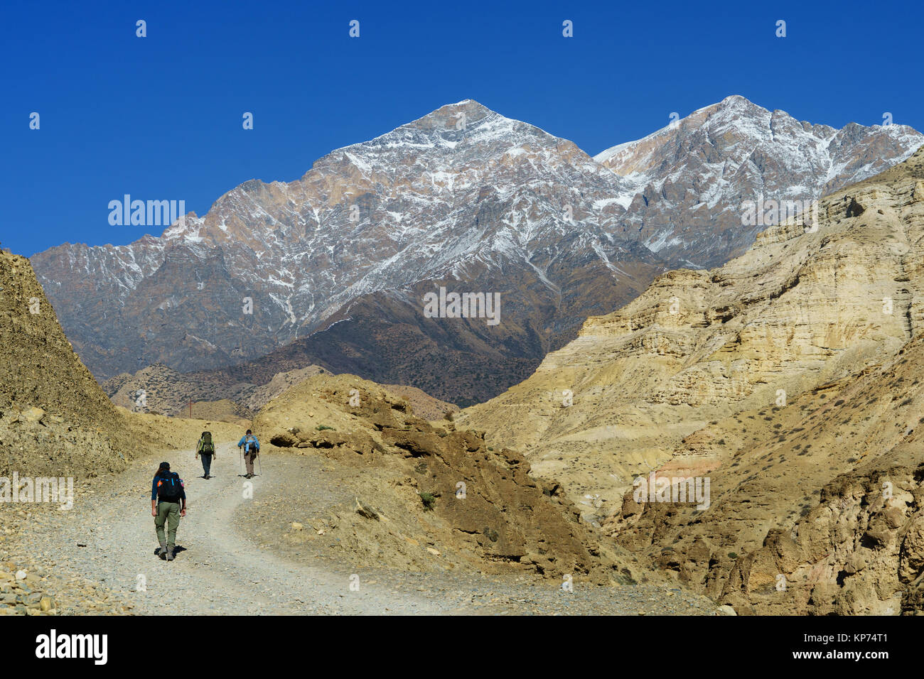 Three trekkers on the trail between Chele and Samar, Upper Mustang region, Nepal. Stock Photo