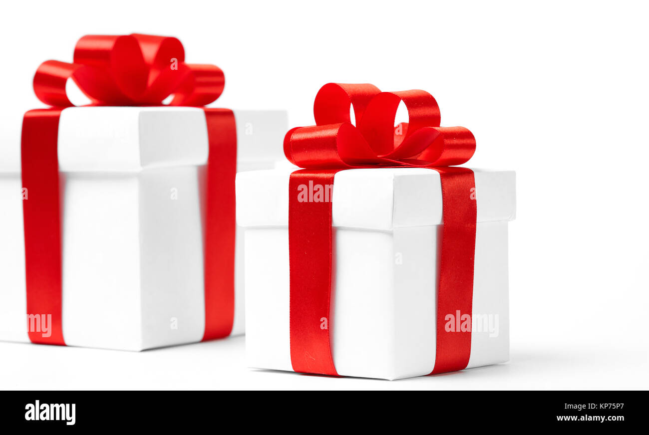 White gift box with red ribbon bow and christmas balls around, isolated ...