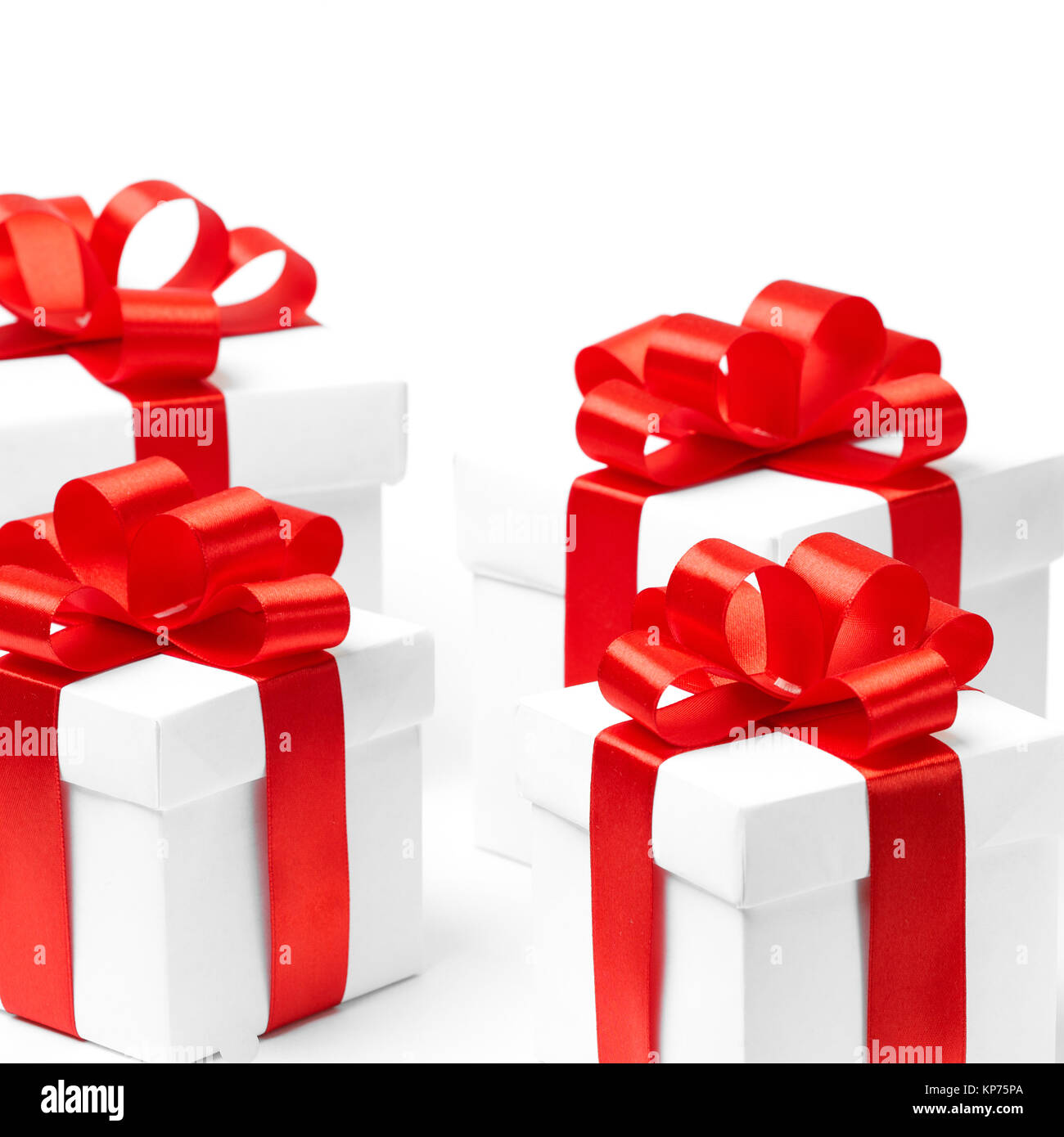 White gift box with red ribbon bow and christmas balls around, isolated ...