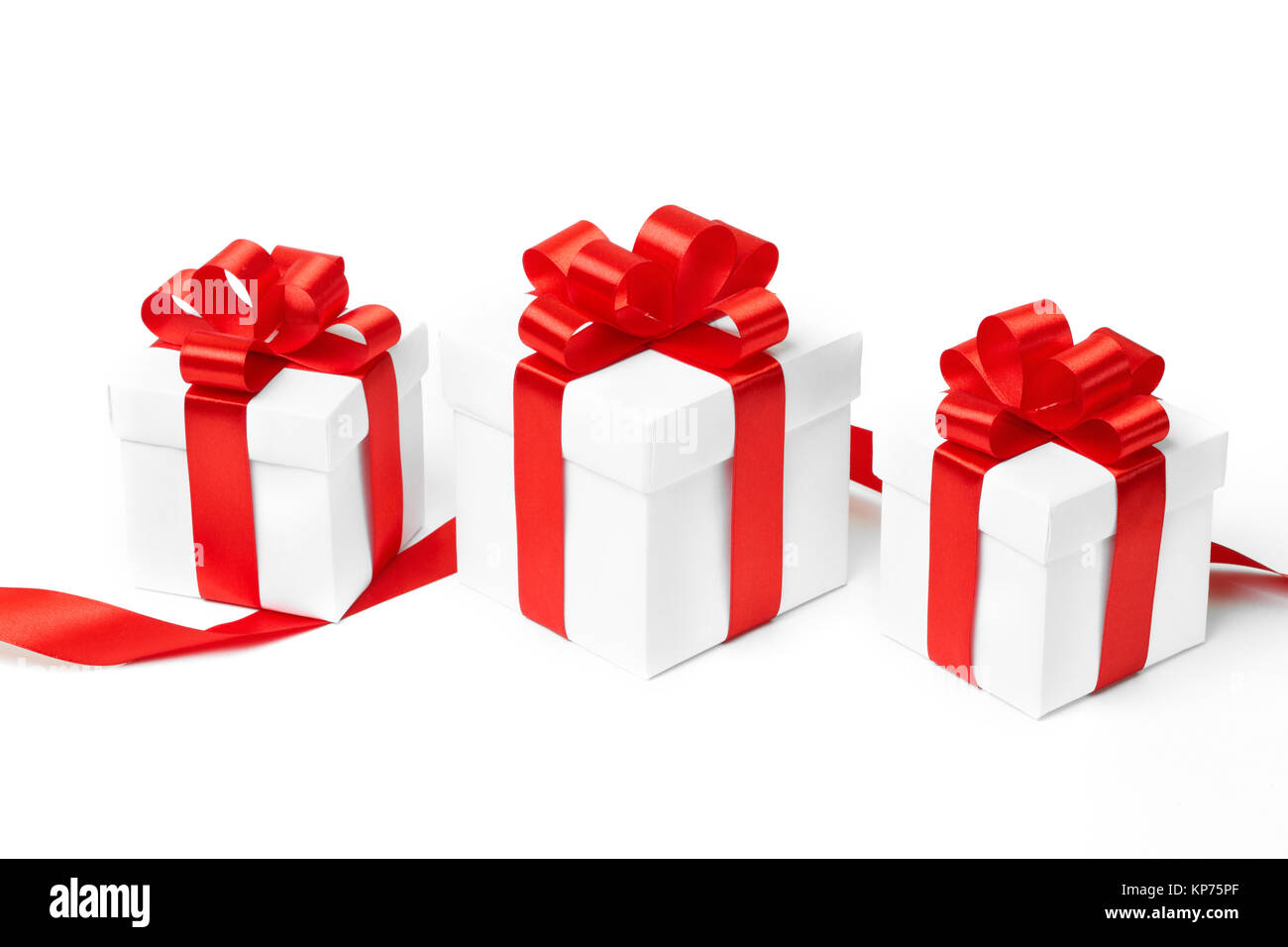 White gift box with red ribbon bow and christmas balls around, isolated ...