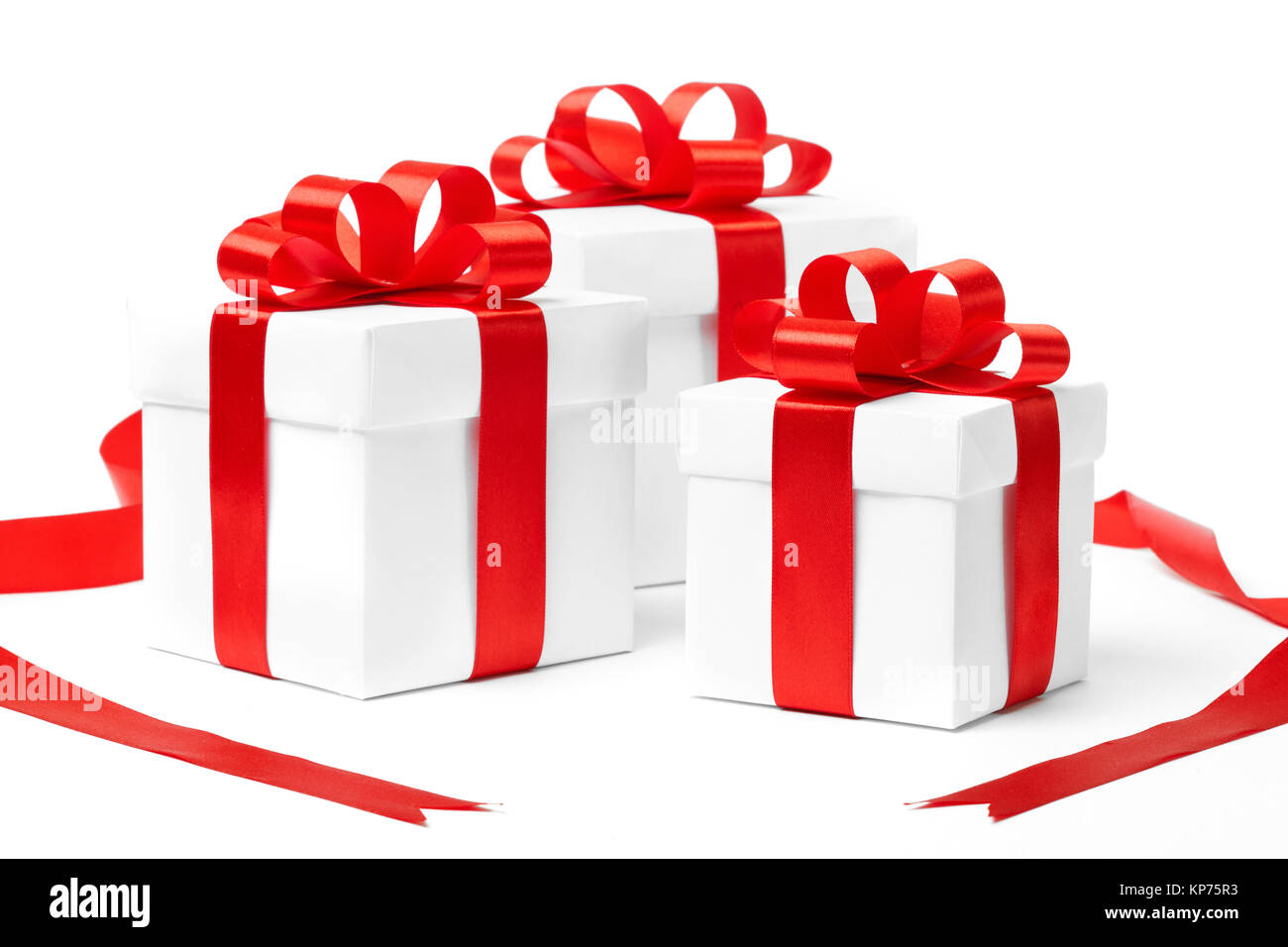 White gift box with red ribbon bow and christmas balls around, isolated ...