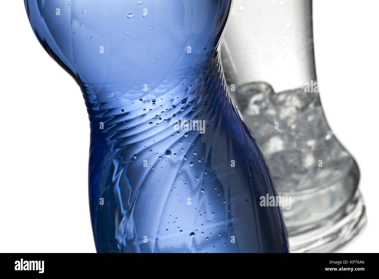 cropped image of blue water bottle and ice cubes in glass Stock Photo ...