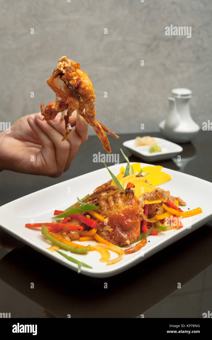 human hands and crab dish Stock Photo Alamy