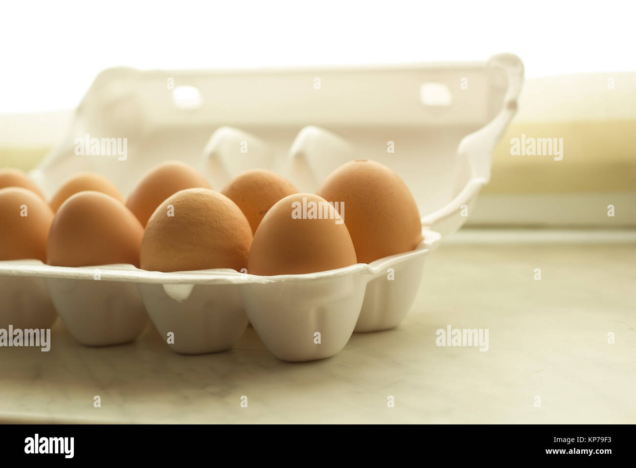 Chicken eggs brown color in white foam packaging selective focus Stock