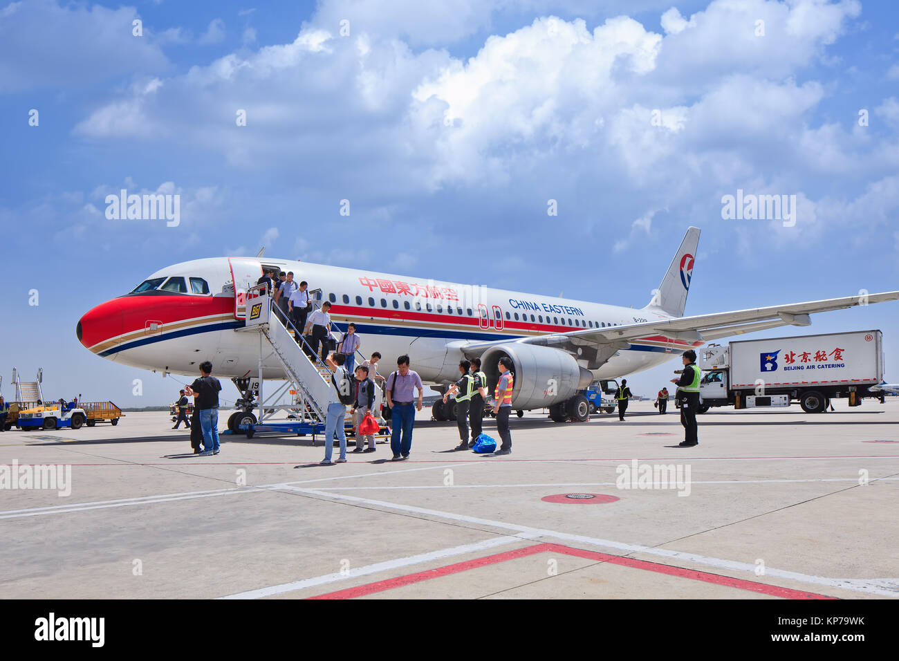 BEIJING-MAY 27, 2014. Passengers come out airplane on Beijing Airport. Because of China's prosperity a growing middle-class want to travel. Stock Photo