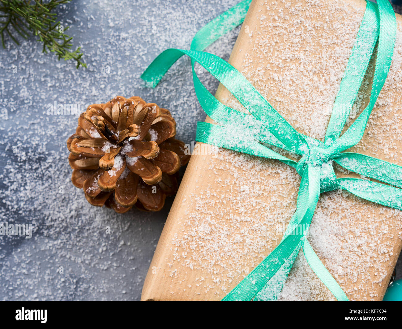 Christmas new year wrapped gift box with ribbon and snow. Pine cones ...