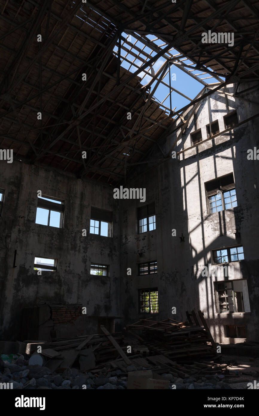 Old abandoned, ruined industry, factory, warehouse; broken and destroyed roof, windows; sunlight and shadow, interior view, Hualien, Taiwan Stock Photo