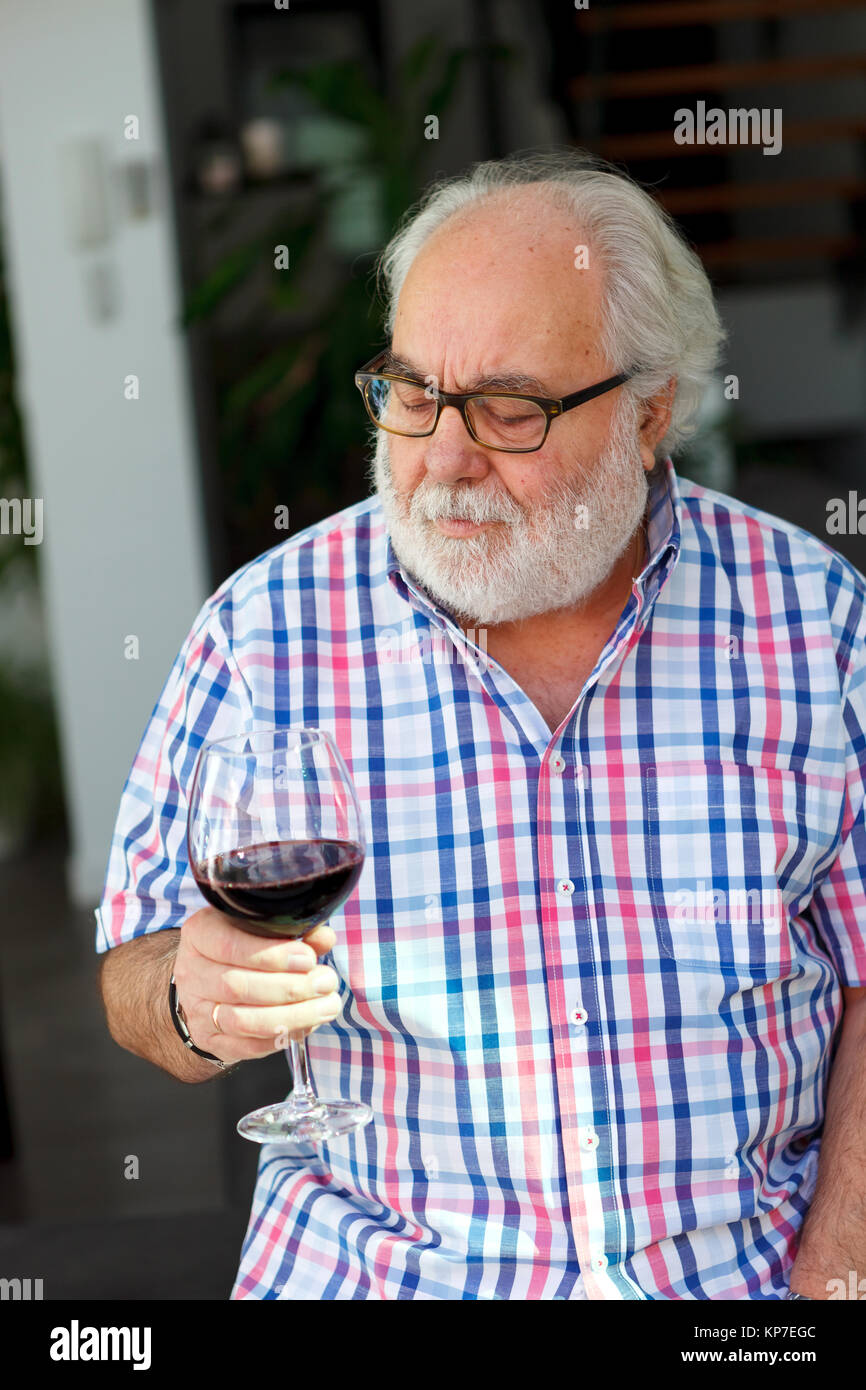 Mature man drinking wine at home Stock Photo - Alamy