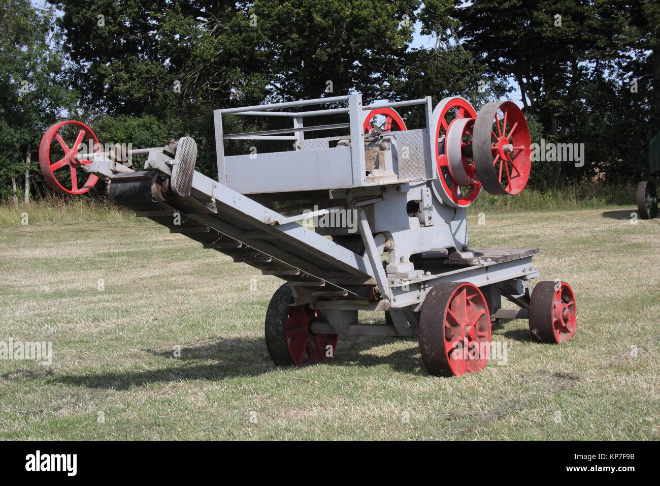 An old belt driven stone crusher, still in use today. Crushing stones for road  tracks, and footings. Stock Photo