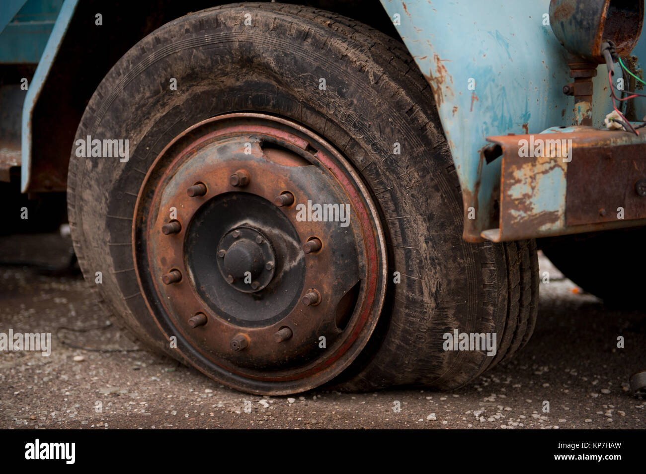 Old ruined truck tire, flat tire on rusted wheel Stock Photo - Alamy