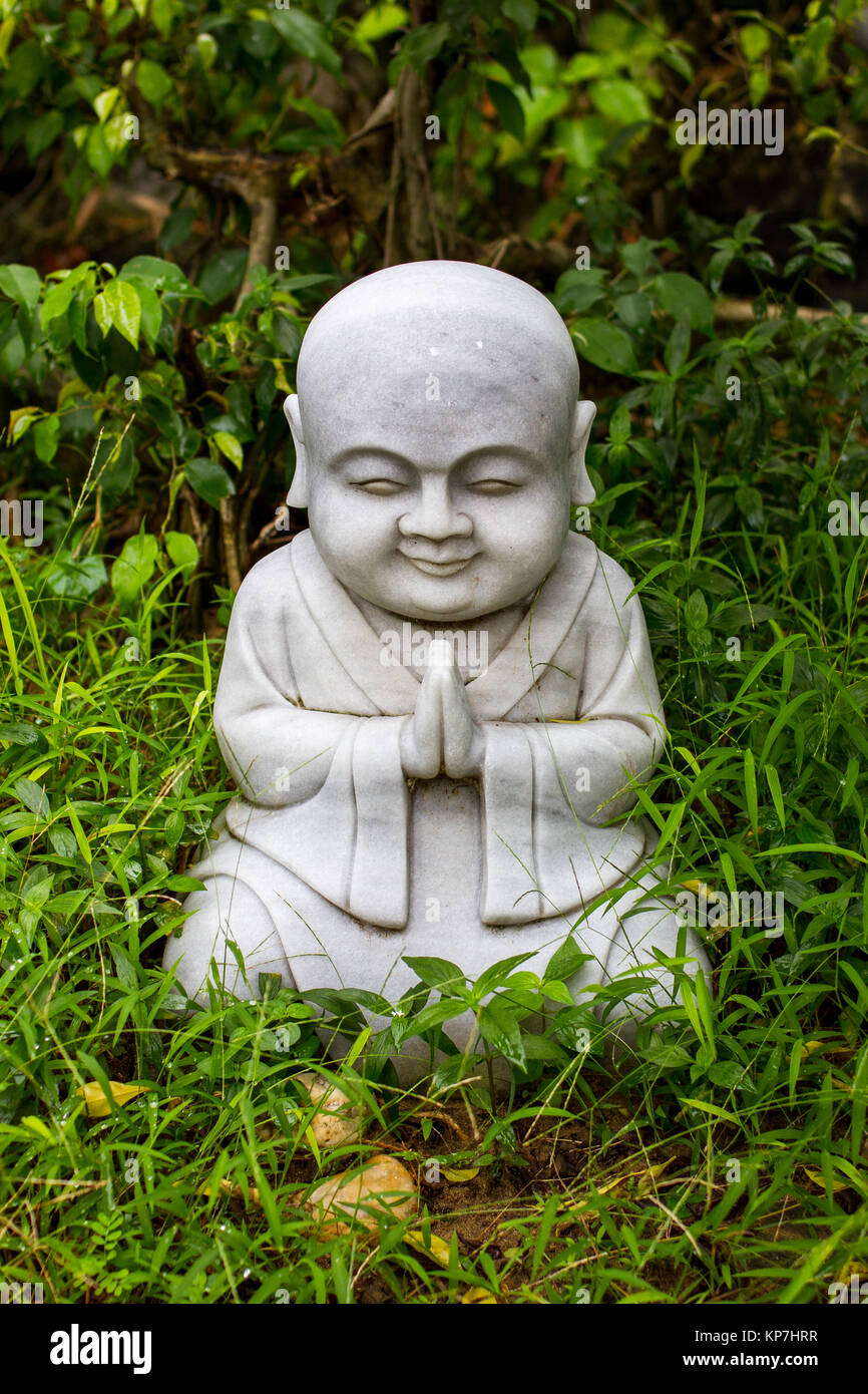 Little buddha statue in the garden of a temple in Vietnam Stock Photo -  Alamy