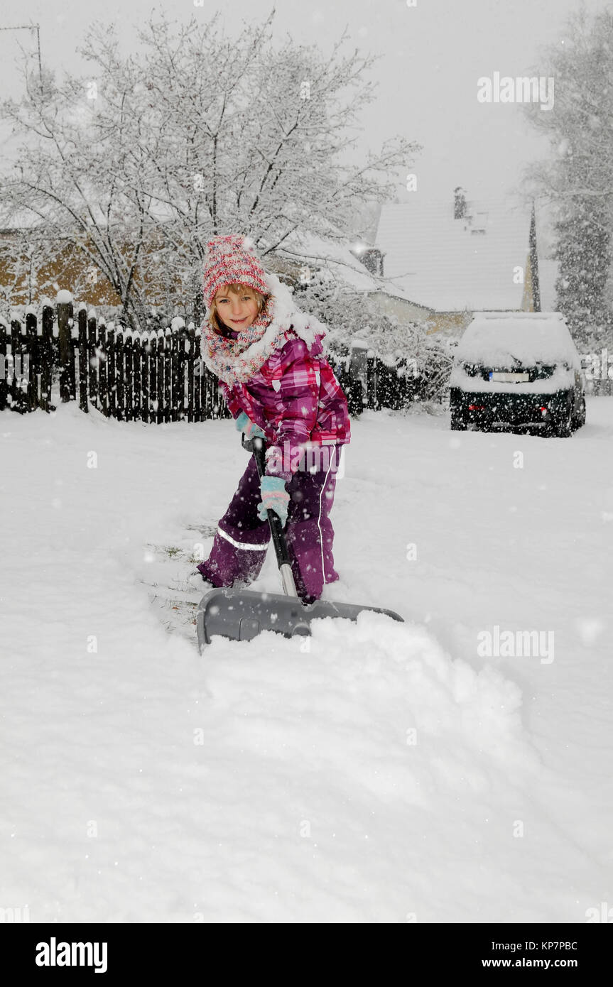 child with snow shovel Stock Photo Alamy