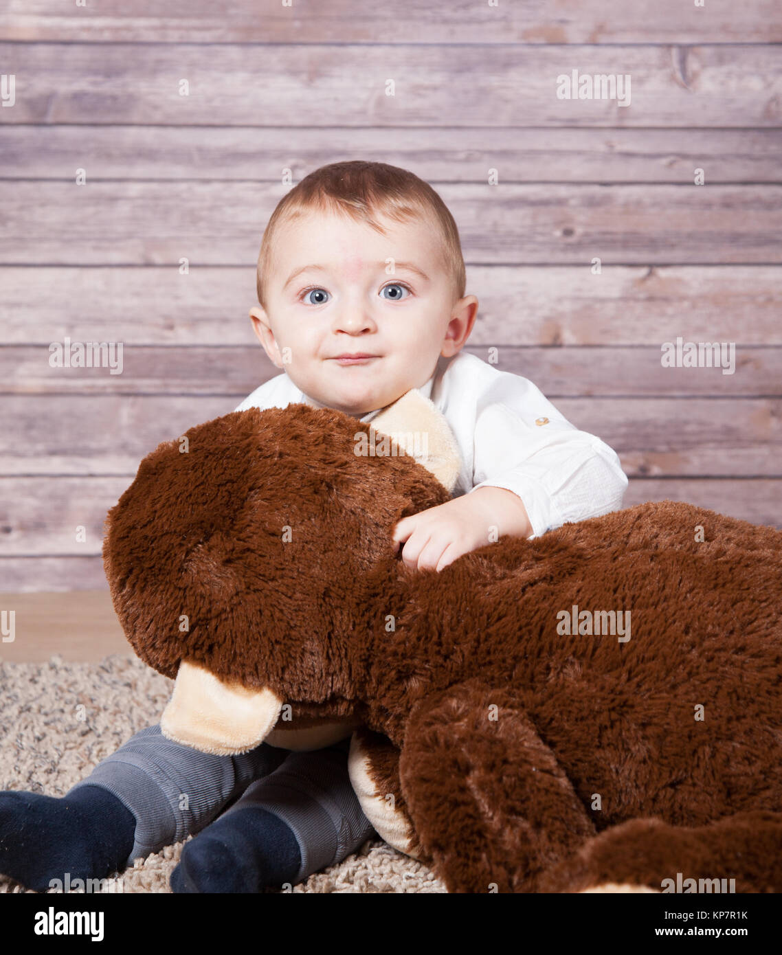Baby boy with huge monkey toy Stock Photo