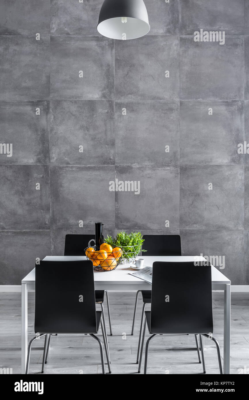 Wall from square concrete tiles in dining room with modern furniture Stock  Photo - Alamy, image size:866x1390