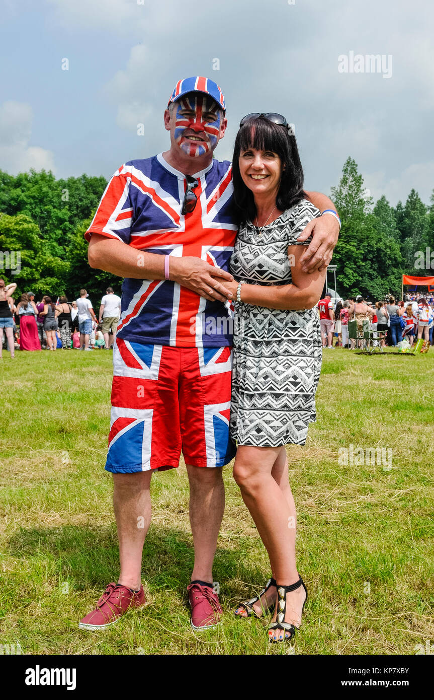 A man wears Union Jack clothing and a hat, with his wife. Stock Photo