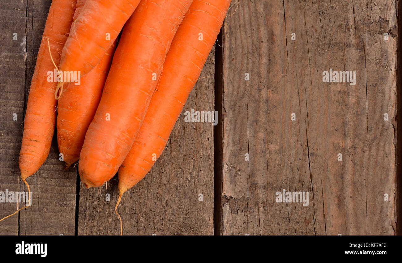 Fresh carrots on wood Stock Photo Alamy