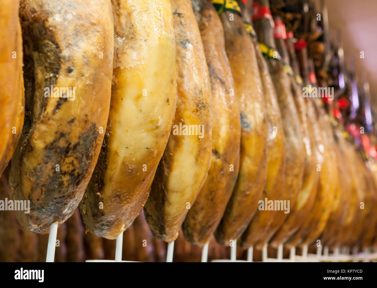 Line of cured iberico ham hanging legs Stock Photo