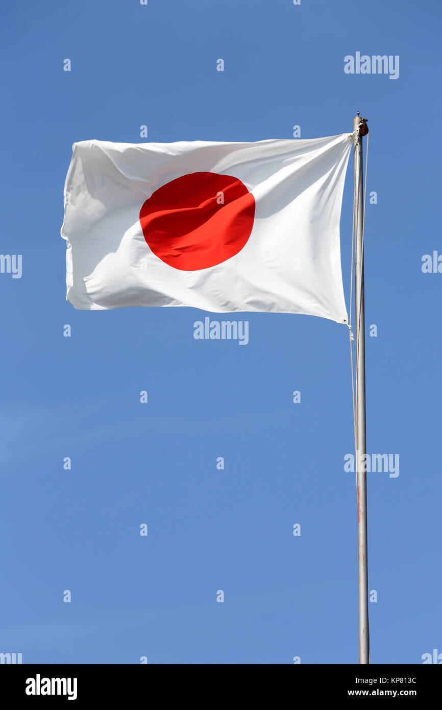 Japanese flag in wind against a blue sky Stock Photo