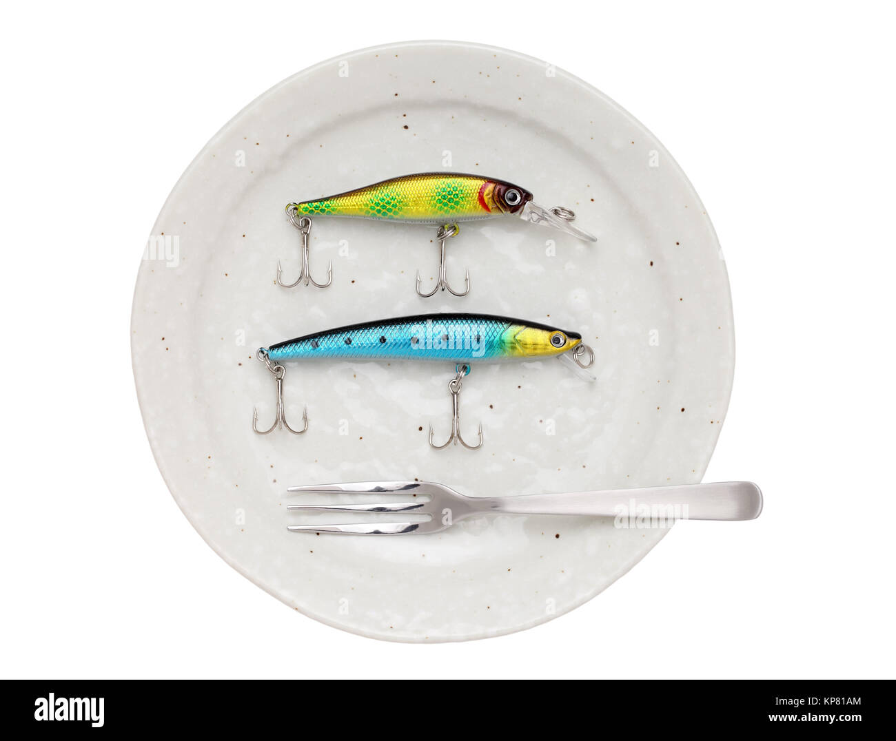 Plastic fishing lure on plate Stock Photo
