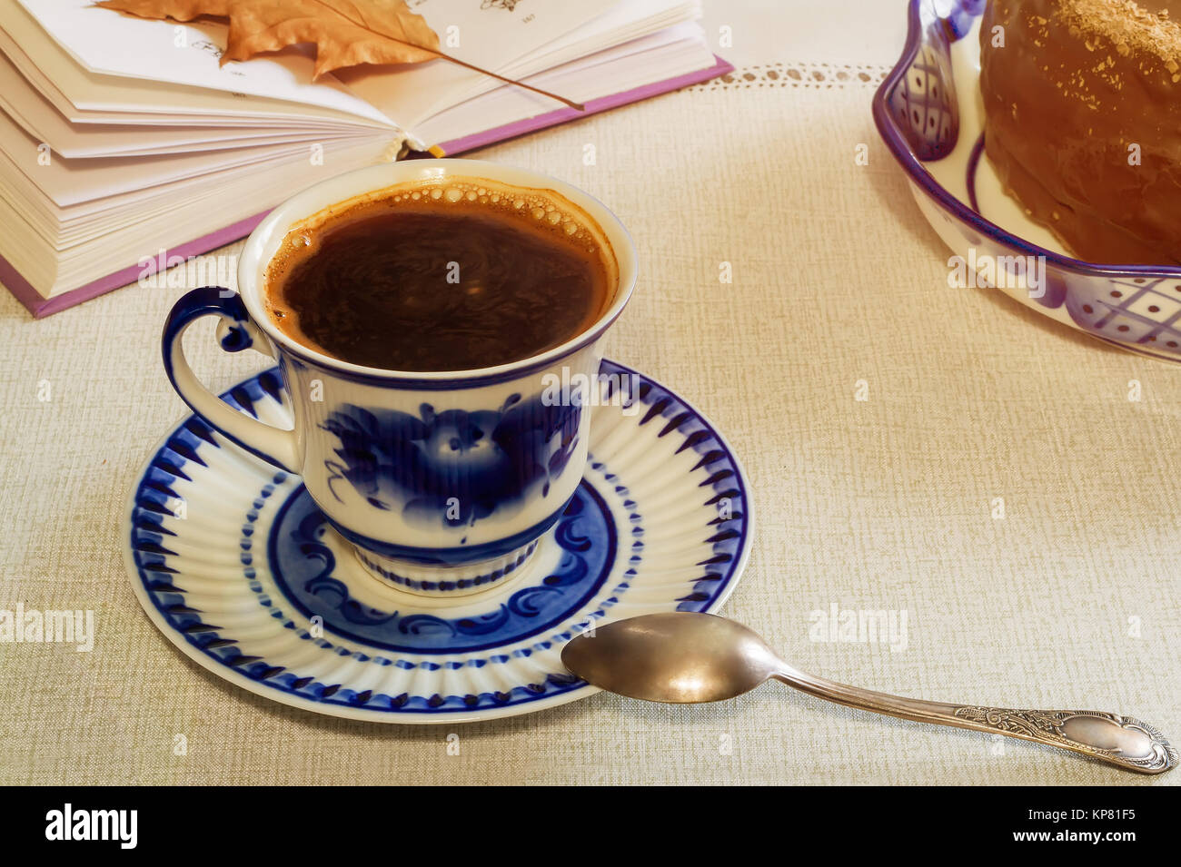 A Cup of black coffee and cake on the table. Stock Photo