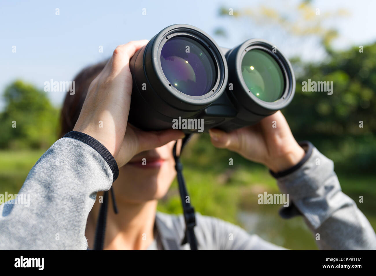Young woman using binocular for bird watching Stock Photo Alamy