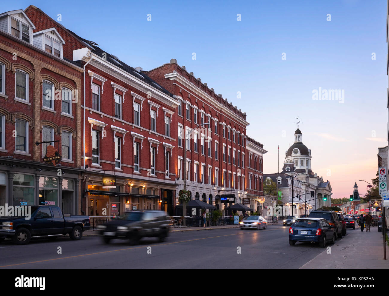Historical buildings line Ontario Street with Kingston City Hall in the distance in downtown Kingston, Ontario, Canada. Stock Photo
