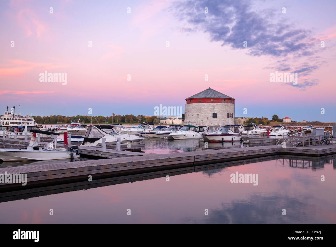 The Confederation Basin Marina and Shoal Tower which is a World War 2 Martello Tower on the St. Lawrence River at sunset in Kingston, Ontario, Canada. Stock Photo
