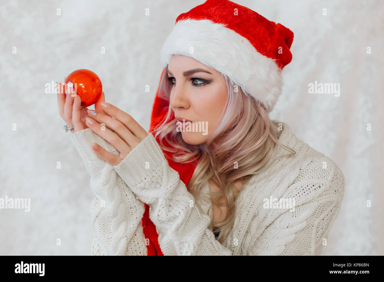 Happy excited young woman in santa claus hat Stock Photo - Alamy