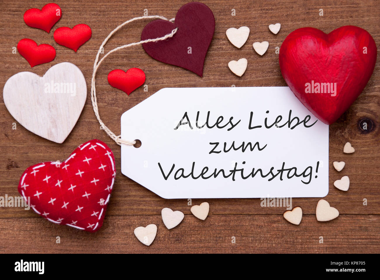 Label With Red Textile Hearts On Wooden Background. German Text Alles Liebe Zum Valentinstag Means Happy Valentines Day. Retro Or Vintage Style Stock Photo