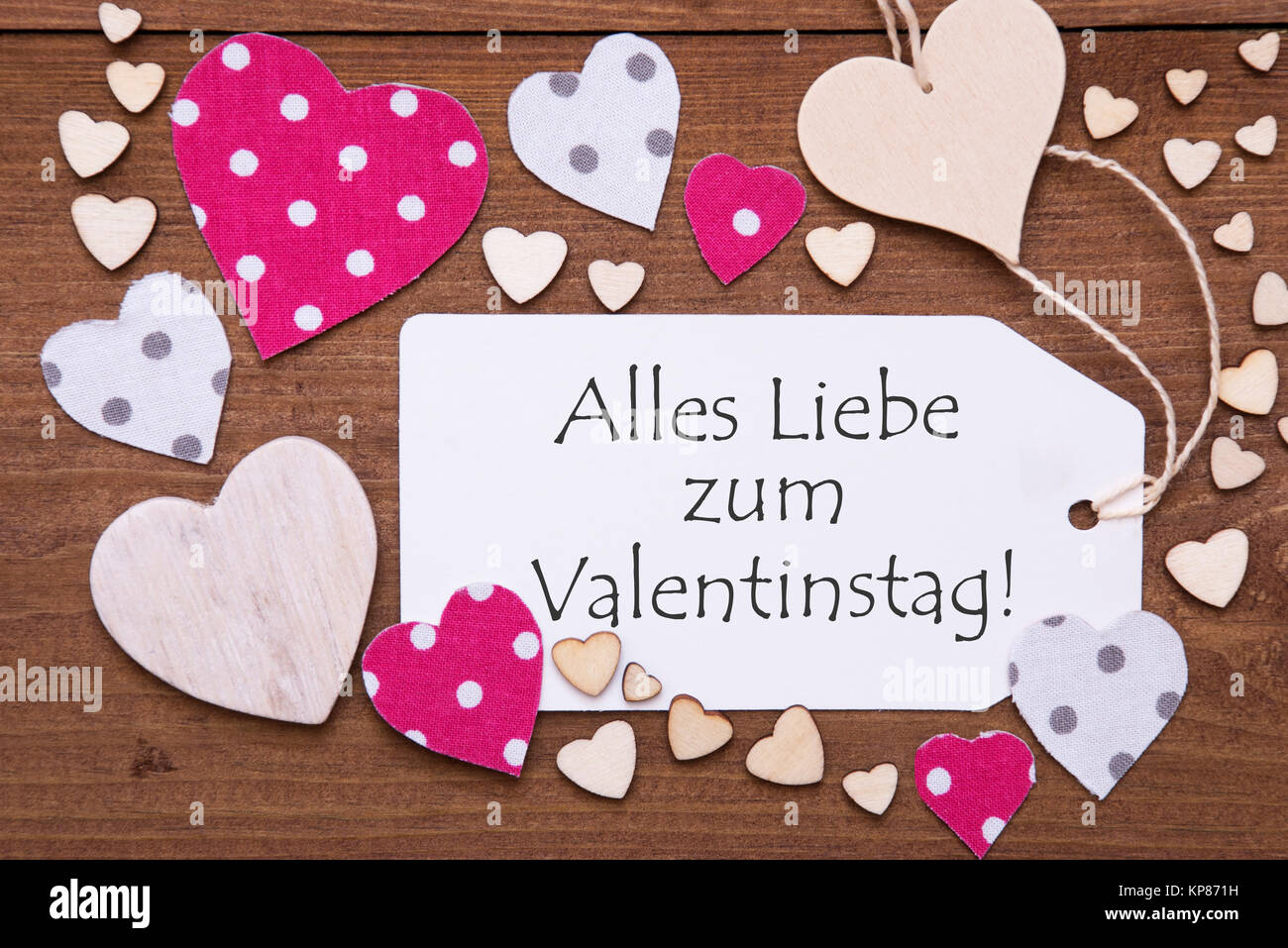 Label With Pink Textile Hearts On Wooden Background German Text Stock Photo Alamy