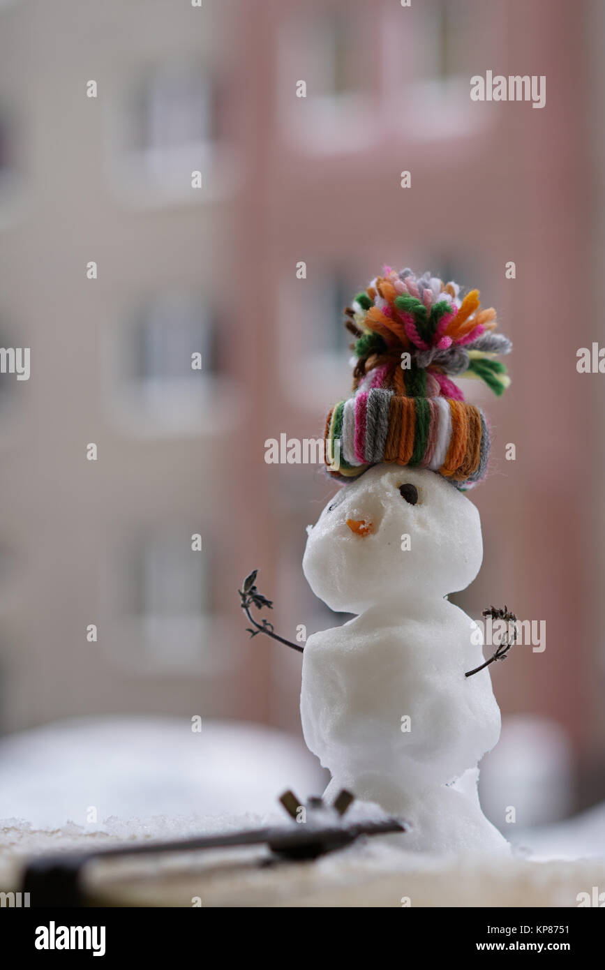 snowman in winter on a balcony railing Stock Photo