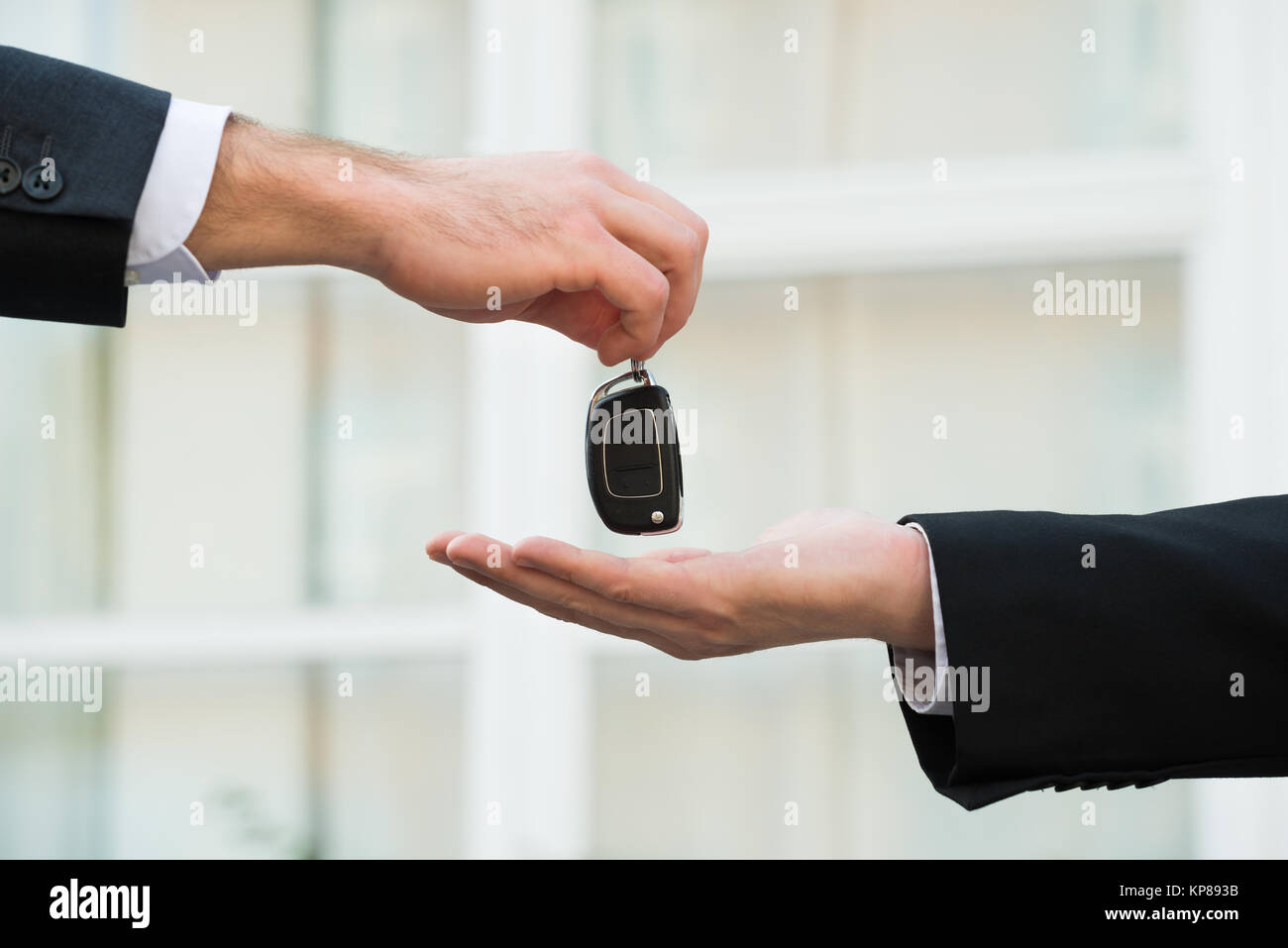 Car Dealer Giving Keys To Businessman Stock Photo Alamy