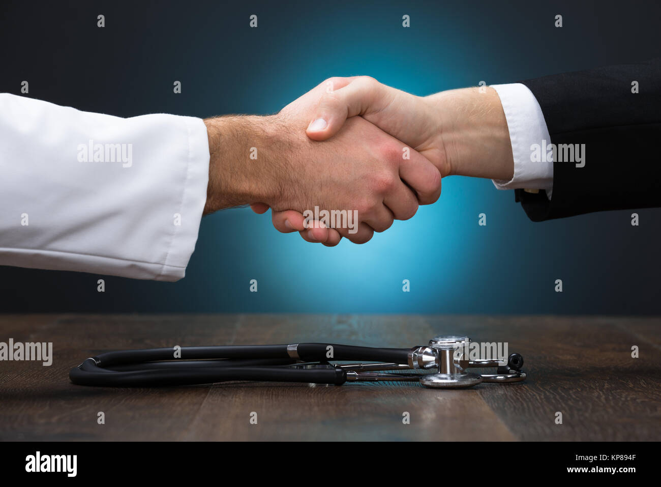 Cropped Image Of Businessman And Doctor Shaking Hands Stock Photo - Alamy