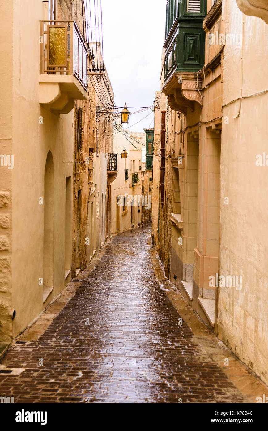 Wet, narrow, cobbled streets in Victoria, Gozo, Malta following a heavy rain storm. Stock Photo