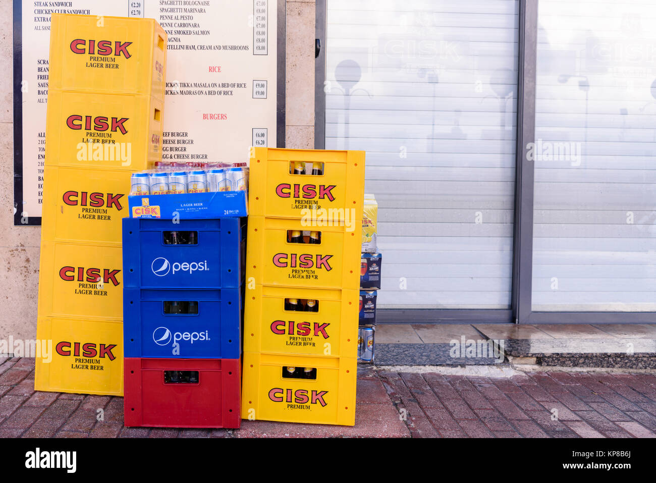 Delivery of Cisk lager, Pepsi and other drinks left outside a bar restaurant in Malta. Stock Photo