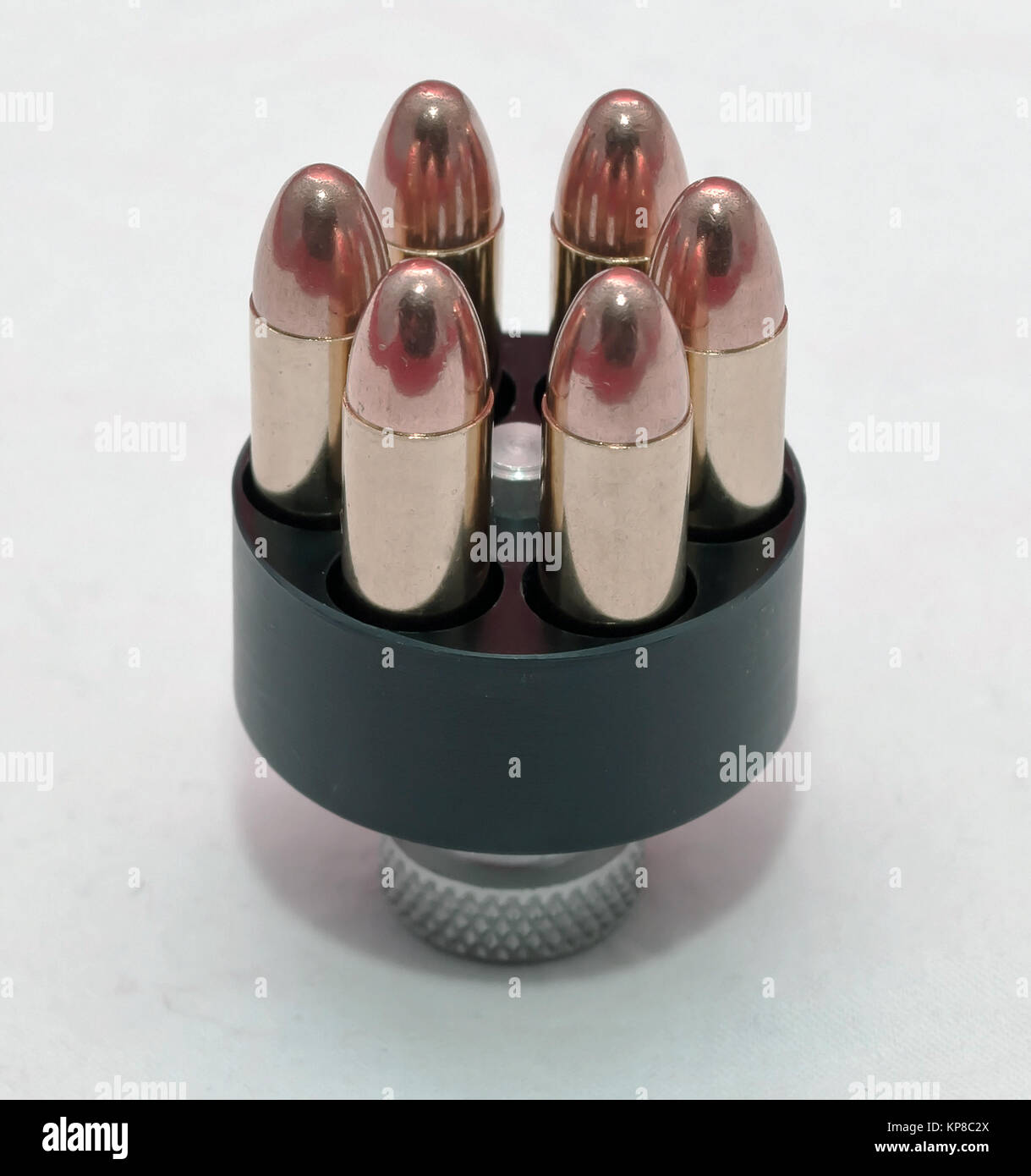 A loaded speed loader for a revolver on a white background Stock Photo