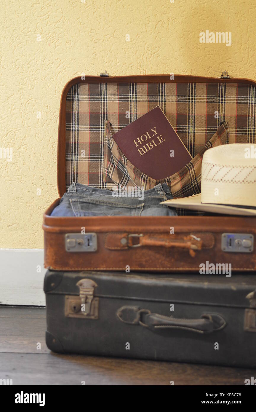 packed suitcase with clothes and a Bible Stock Photo