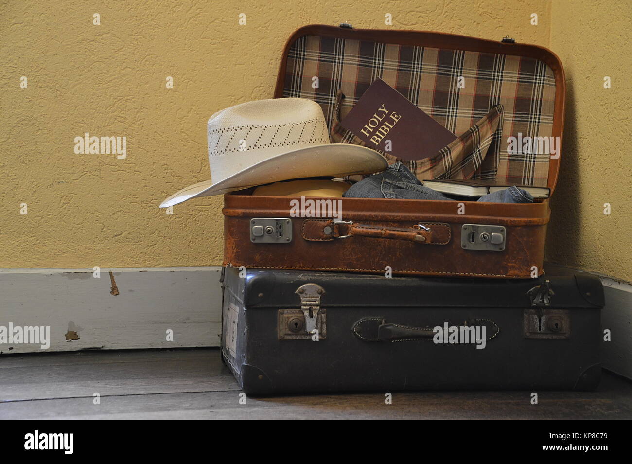 packed suitcase with clothes and a Bible Stock Photo