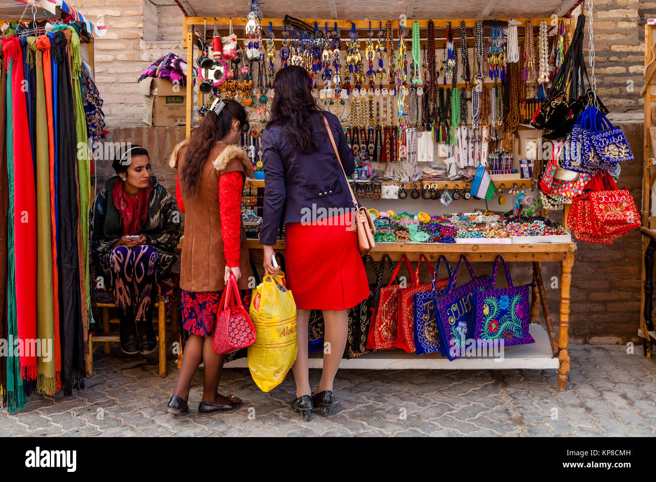 Local Uzbek Women Shopping At Colourful Stall, Khiva, Uzbekistan Stock Photo