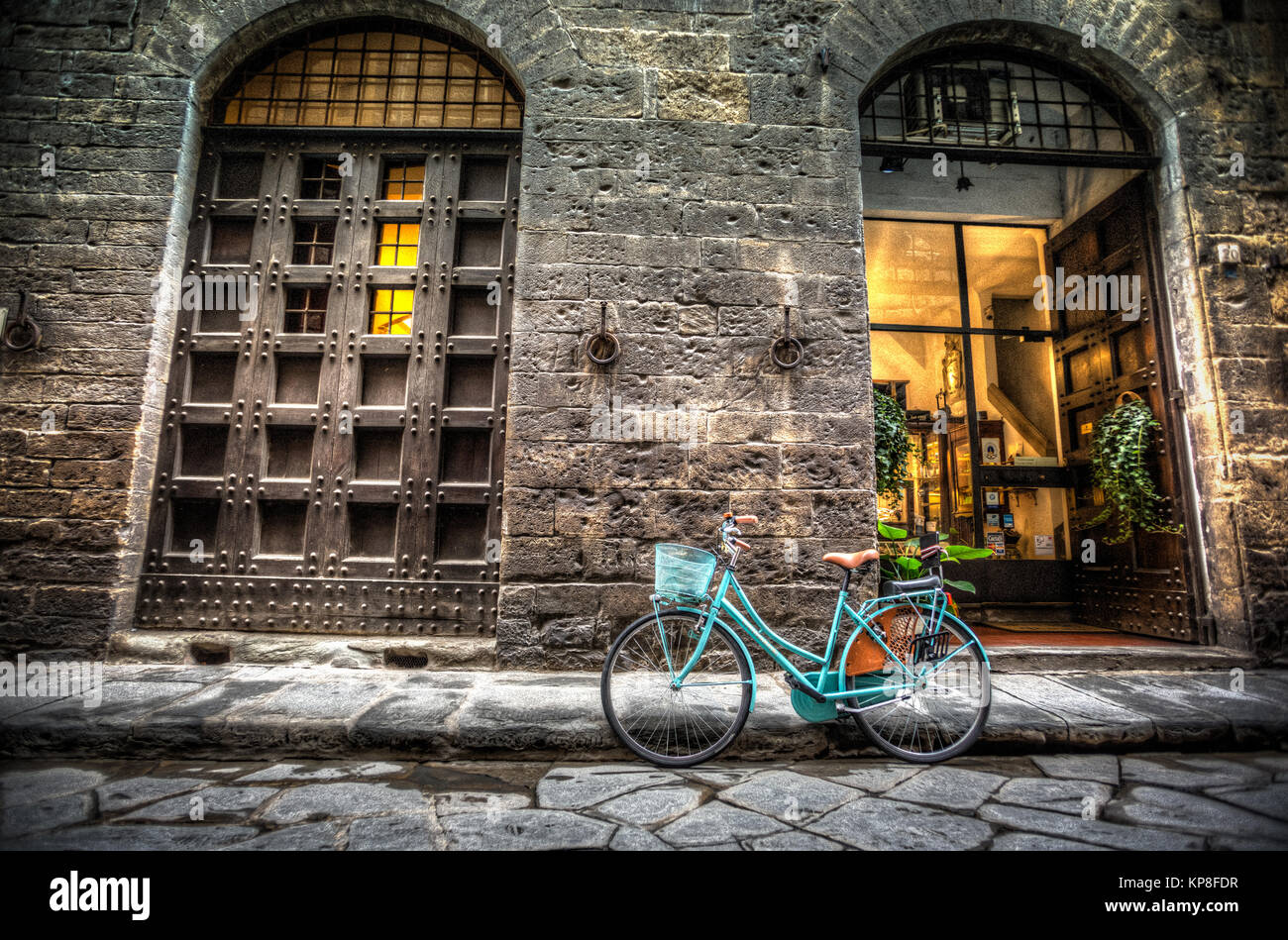 Blue bicycle on cobblestone street in Florence, Italy Stock Photo