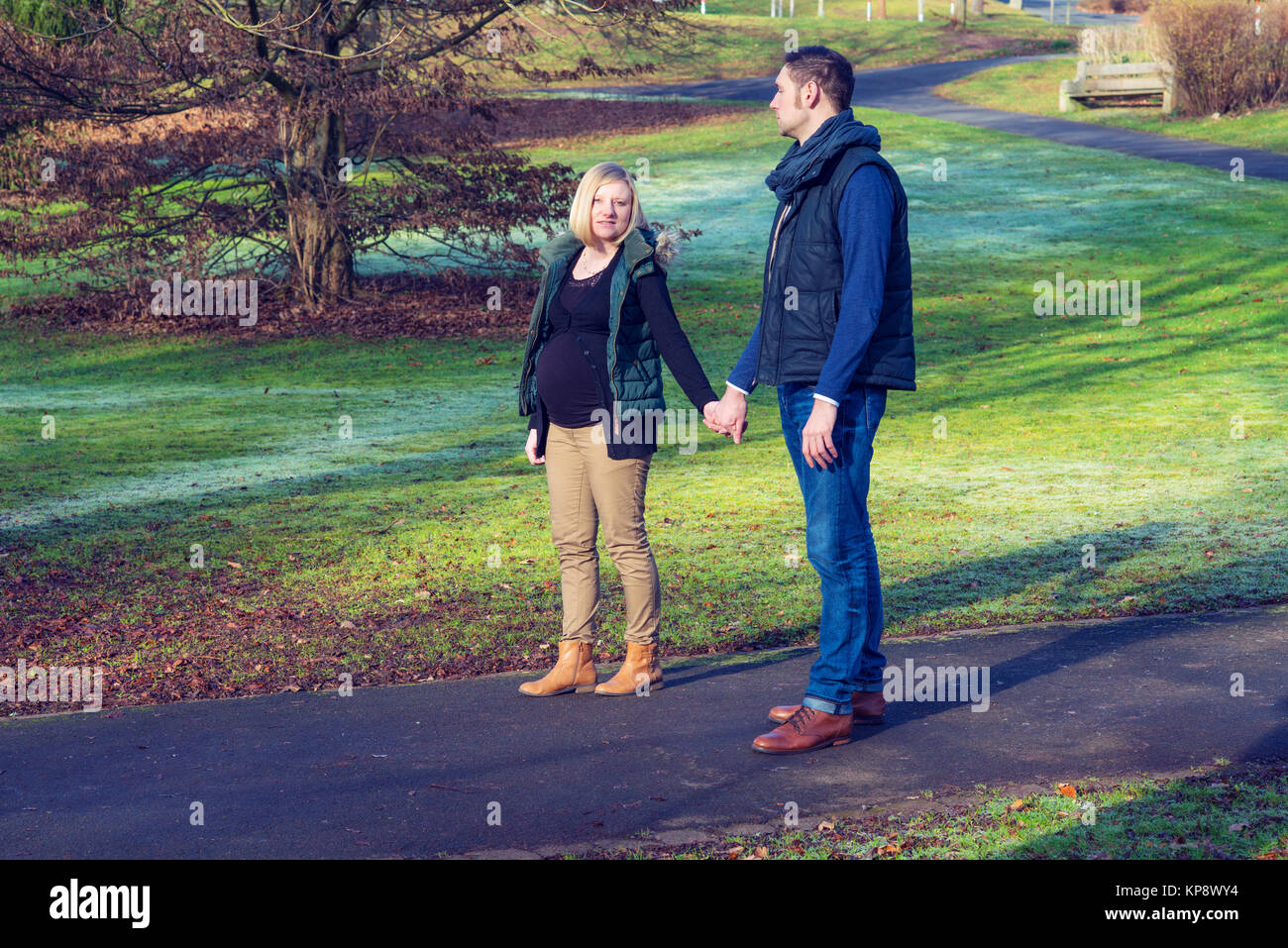 young pregnant woman with her husband in the park Stock Photo - Alamy