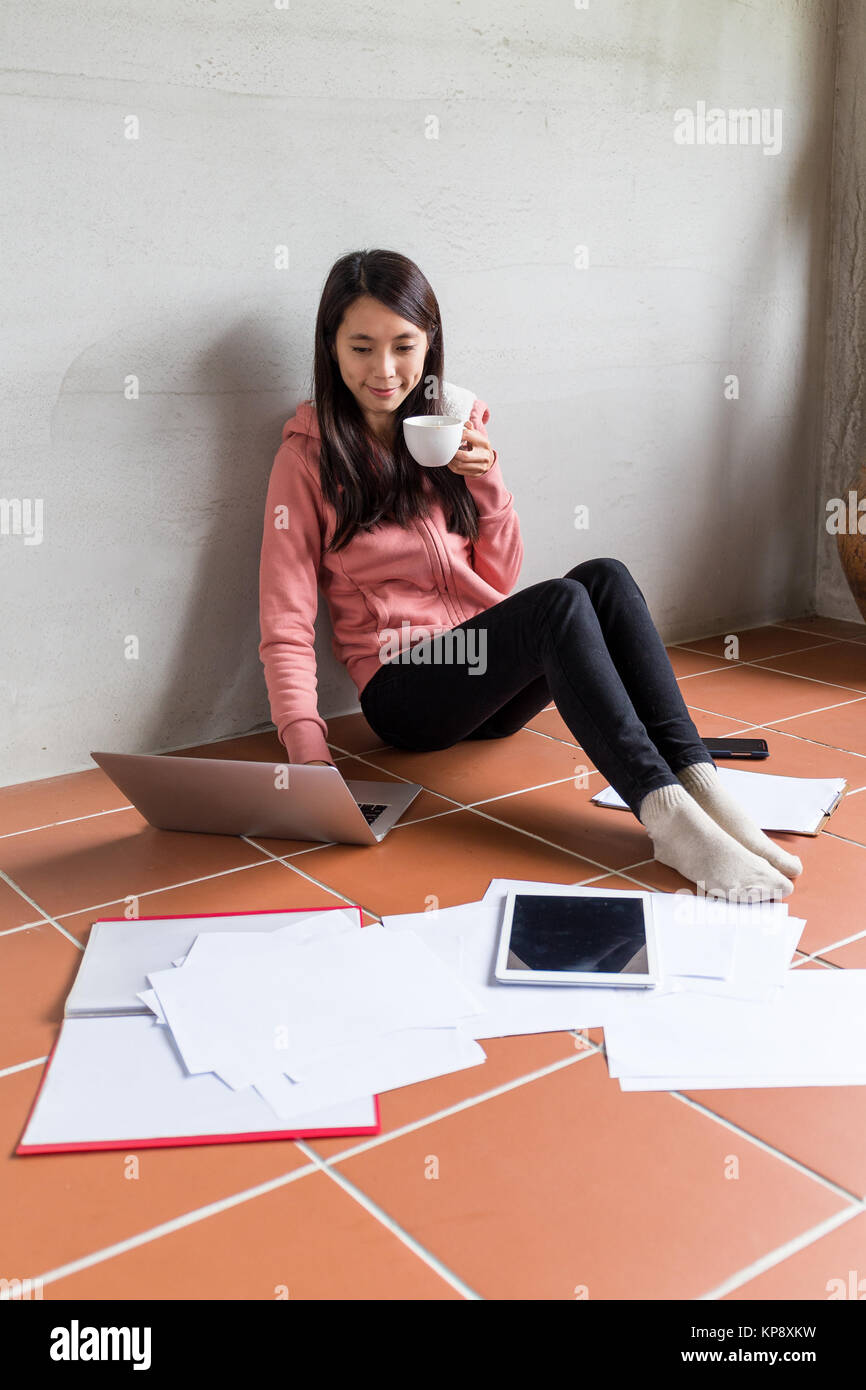 Woman drink a cup of tea with her messy work Stock Photo - Alamy