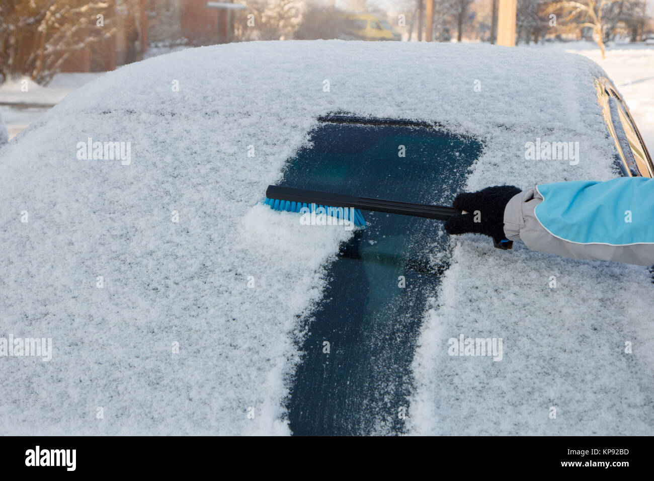 Clearing snow off a car Stock Photo Alamy